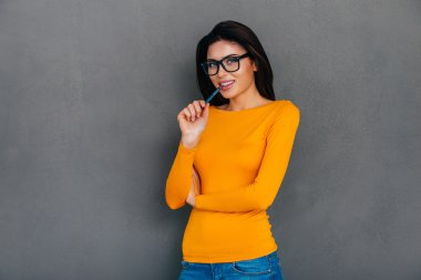 woman carrying pen in mouth