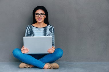 woman carrying laptop on her knees
