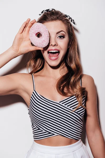 Vrouw op zoek via donut — Stockfoto