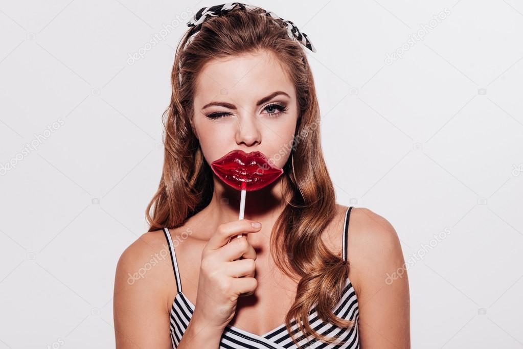woman holding a lollipop
