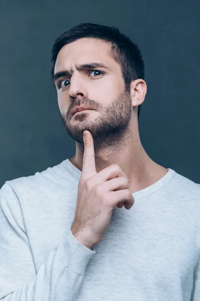 Frustrato uomo toccando mento con — Foto Stock