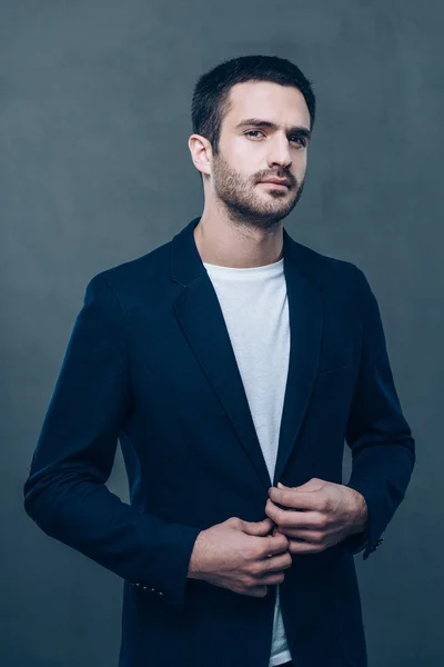 Handsome man adjusting jacket — Stock Photo, Image