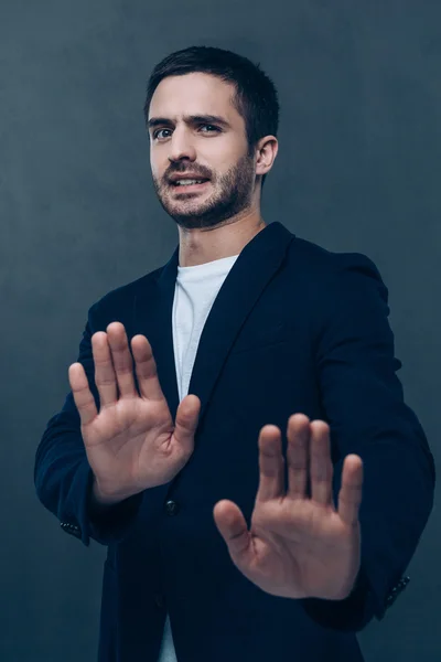 Frustrated young man gesturing — Stock Photo, Image