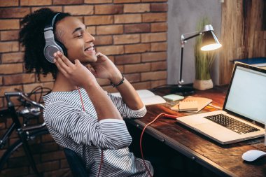 African man adjusting headphones
