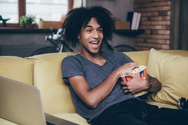 African man watching TV