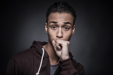 African man covering his mouth with fist