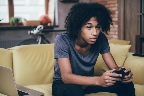 Young African man holding joystick — Stok fotoğraf