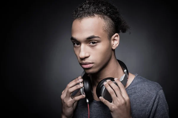 African man adjusting headphones — Stock Photo, Image