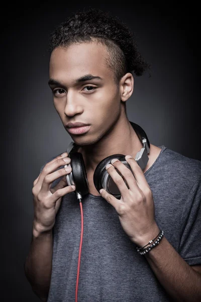 African man adjusting headphones — Stock Photo, Image