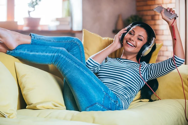 Woman adjusting her headphones — Stock Photo, Image