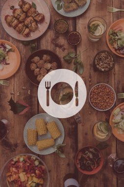 wooden table full of food and drinks