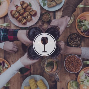 four people cheering with red wine