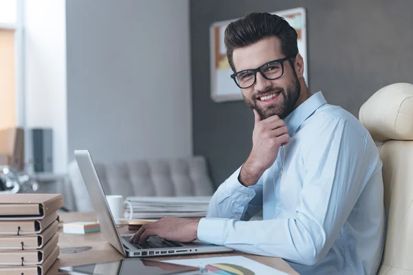 Handsome working with laptop in office — Stock Photo, Image
