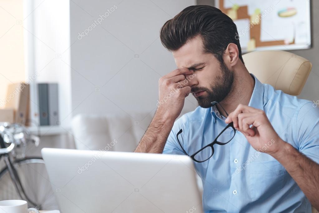 Handsome working with laptop in office