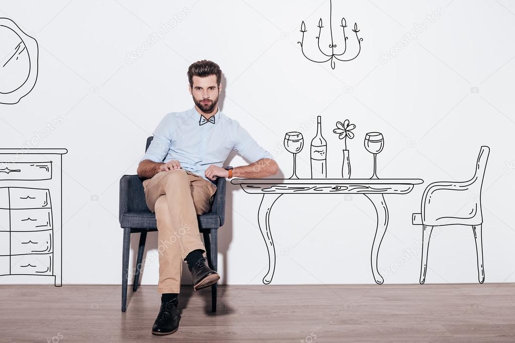 handsome man sitting at dining table
