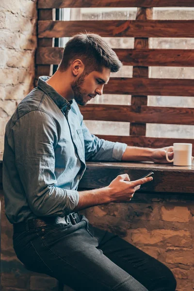 Bystrý mladý muž s Kobaltová modř telefon — Stock fotografie