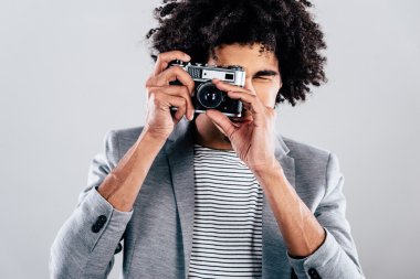 African man holding retro camera