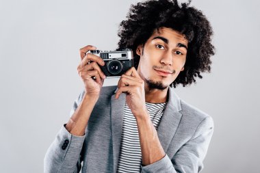 African man holding retro  camera
