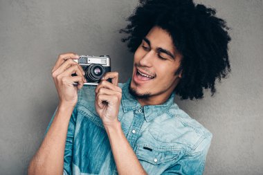 African man holding retro  camera