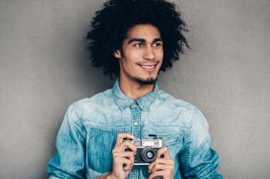 African man holding retro  camera