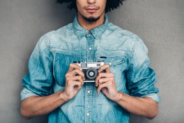 African man holding retro  camera