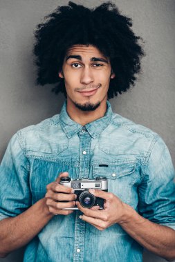 African man holding retro  camera