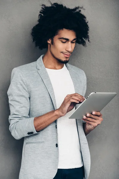 African man working on his digital tablet — стокове фото