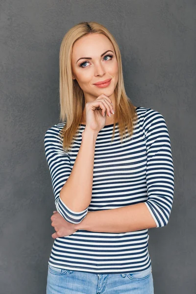 young pensive woman keeping hand