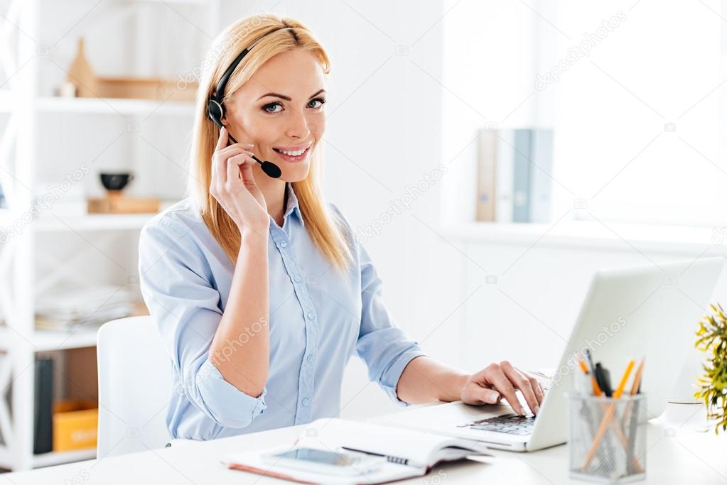 woman in headphones working on laptop