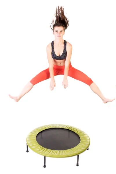 Woman using trampoline — Stock Photo, Image