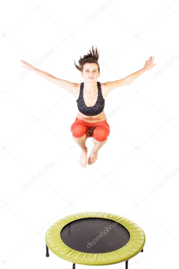 Woman bouncing on trampoline