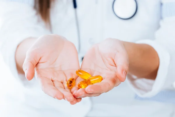 Yellow pills in hands