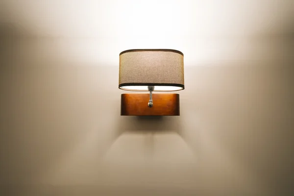 Modern lamp hanging on a white wall — Stock Photo, Image