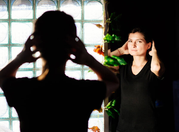 Sensual woman arranging herself on the mirror