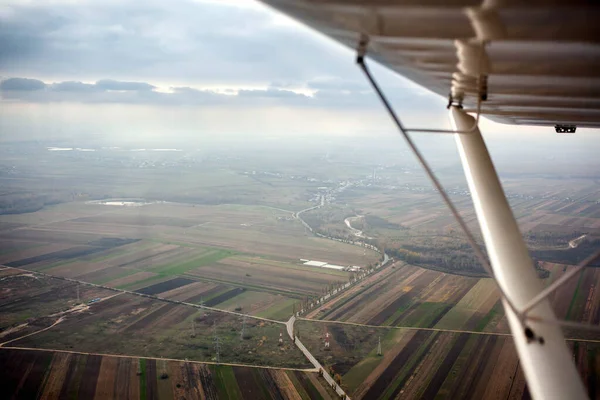 Low angle view of aircraft wing and high angle view of beautiful landscapes