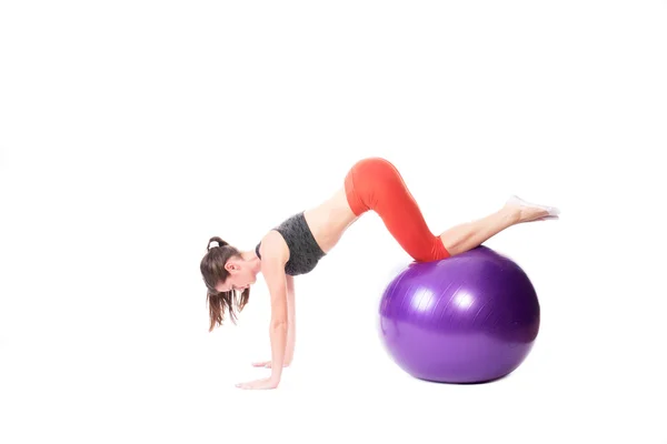 Doing push-ups on exercise ball — Stock Photo, Image