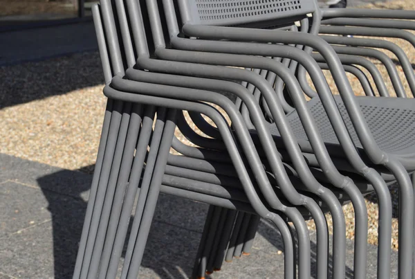 Metal outdoor chairs stacked together