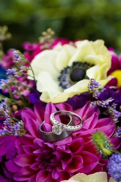 Trauringe für Braut und Bräutigam an Blumen — Stockfoto