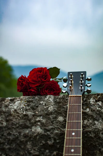 Guitar and roses laying on the fence of Roman Bridge in Sarajevo, Bosnia and Herzegovina