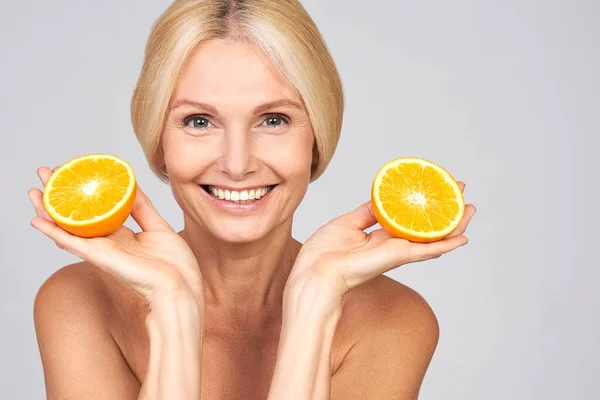 Mature Woman Radiant Complexion Holds Orange Her Hands Beautiful Smiling — 스톡 사진