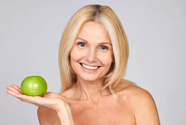 美しい高齢者の女性は リンゴを保持の肖像画 灰色の背景に孤立した ハッピー ウーマン ホールディング グラニー スミス アップル 歯の概念 — ストック写真