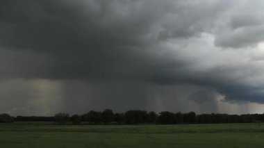 Zaman atlamalı bir şiddetli yağmur duş düz bir kırsal manzara üzerinde