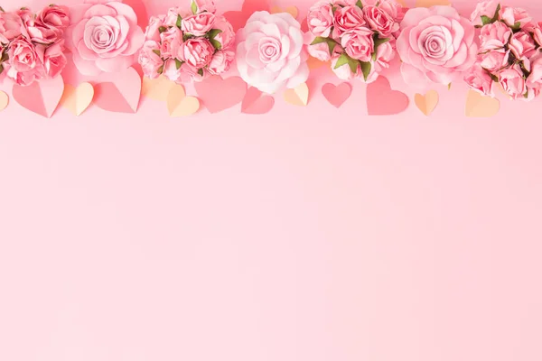 Valentines day background. Border frame of pink flowers and hearts on pink background. Happy Valentine's Day banners. Pastel tone. Copy space.