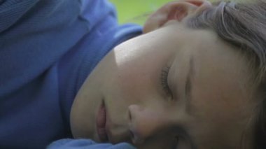 Üzgün çocuk kameraya benziyor. Kameraya bakarak üzgün çocuk portresi. Çocuk arıyorsunuz kamera sonra gülümsüyor pişmanlık ile. Yüzünü kapat. 