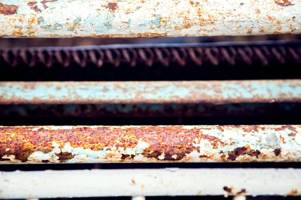 Details of an old rusty iron bed.