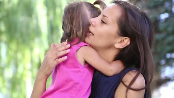 Giovane madre con bambino in un parco cittadino.Madre che gioca con bambino nel parco sull'erba.Famiglia nel parco in vacanza.Mamma con una bambina nella natura . — Video Stock