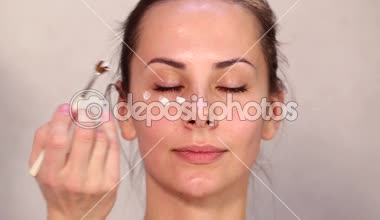 Makyaj yüz kız yakın çekim. Kız portresi bir güzellik salonu kapatın. Yüz, temizlik kozmetik cilt temizliği. Bakımı en büyük planom karşı karşıya. Professionalnaya temizlik cilt.