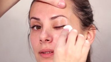 Makyaj yüz kız yakın çekim. Kız portresi bir güzellik salonu kapatın. Yüz, temizlik kozmetik cilt temizliği. Bakımı en büyük planom karşı karşıya. Professionalnaya temizlik cilt.