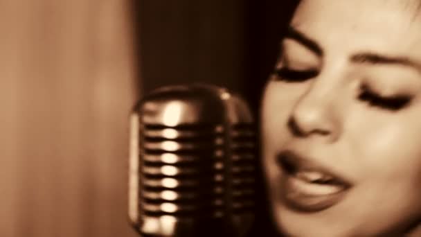 Jovem mulher bonita cantando.A jovem cantora canta no microfone.Close-up retrato da cantora, retro, preto e branco . — Vídeo de Stock