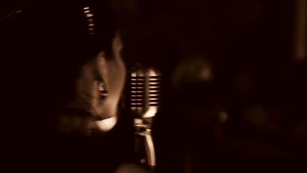 Young beautiful woman singing.The young singer sings into the microphone.Close-up portrait of the singer, retro, black and white. — Stock Video